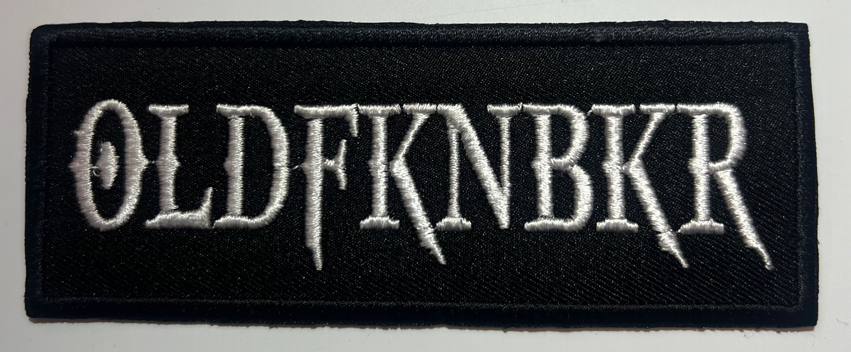 Casual motorcycle gear with OLDFKNBKR patch including motocross, Harley Davidson apparel for men and women, and outlaw biker clothes