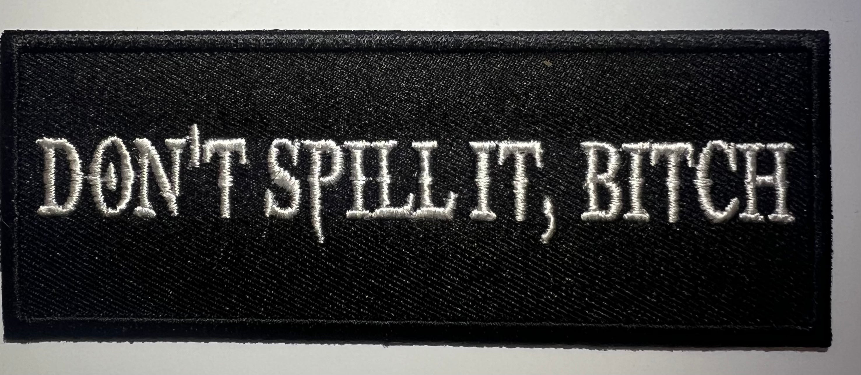 Casual motorcycle gear with 'Don't Spill It, Bitch' patch including motocross, Harley Davidson apparel for men and women, and outlaw biker clothes